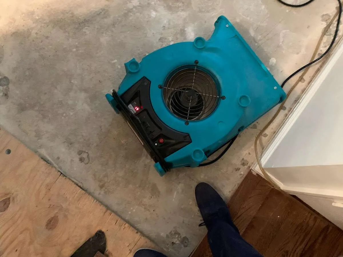 Air mover drying subfloor during Commercial Water Damage Restoration in Mooresville